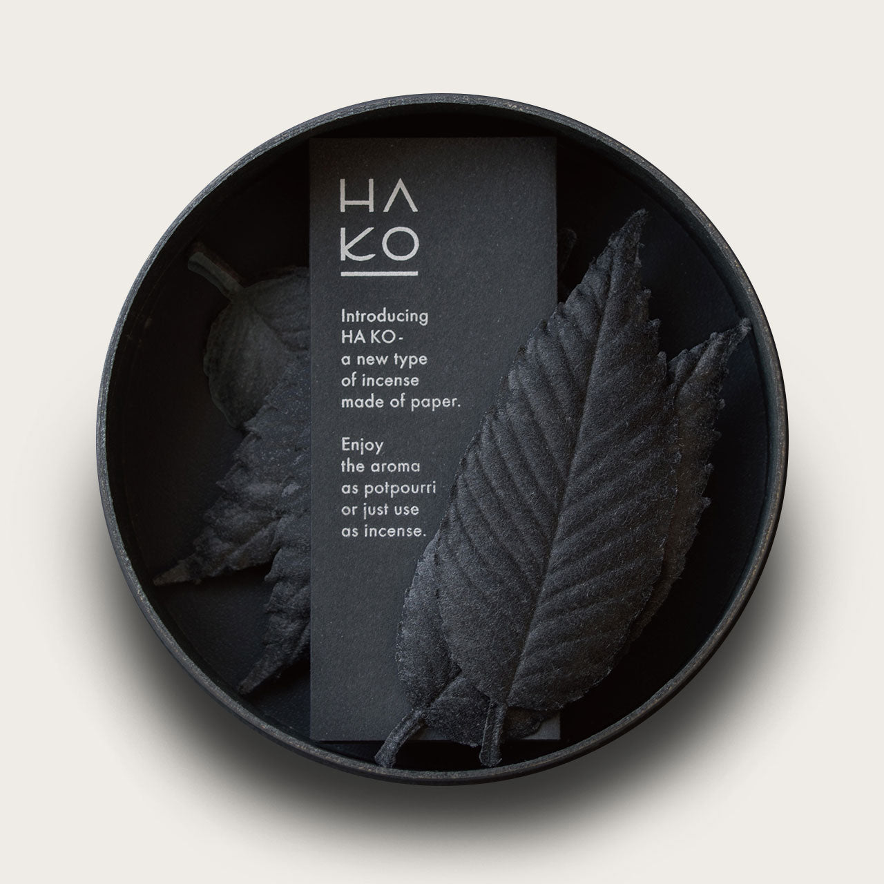 Black incense shaped like leaves in a black circular container