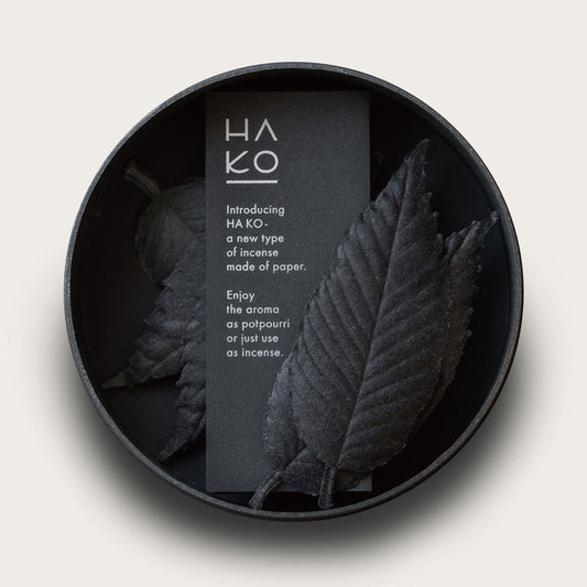 Black incense shaped like leaves in a black circular container