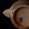Detail of bottom of wooden Hinoki carafe with branded lettering