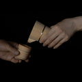 Wooden Hinoki sake carafe pouring sake into a wooden Hinoki sake cup